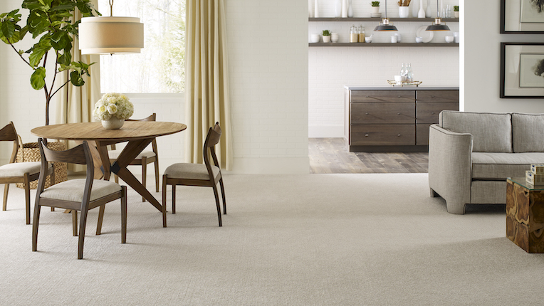 textured off white carpets in a living room and dining room